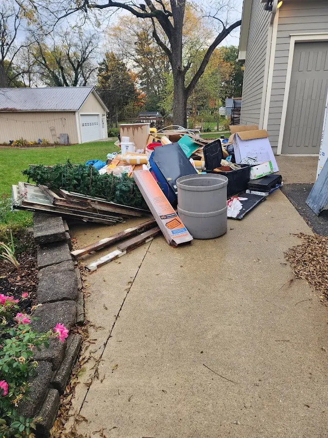 Dumpster being loaded with debris for Commercial Dumpster Rental in Hudson